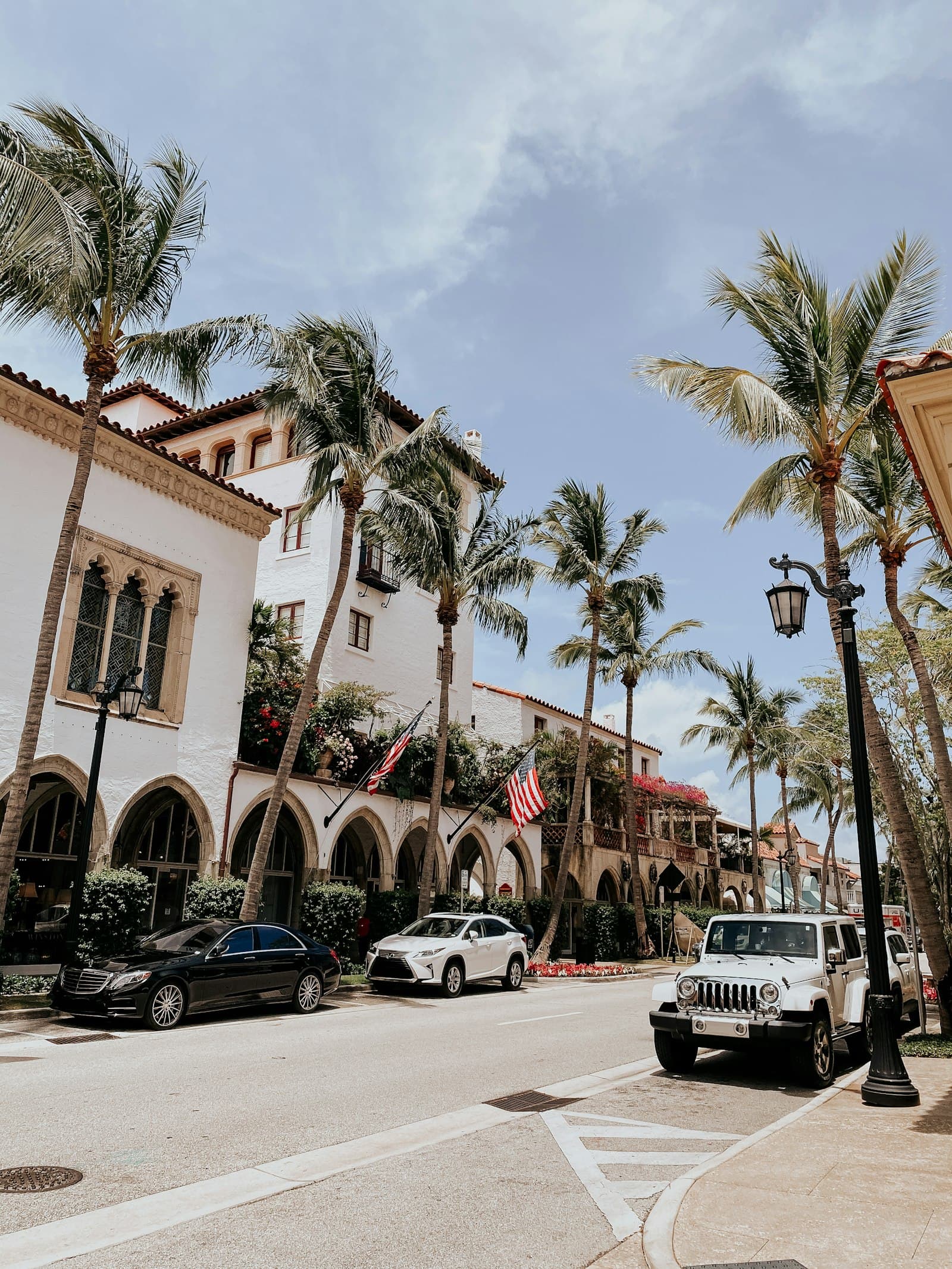 Walkable Florida downtown street with palms and light storefronts.
